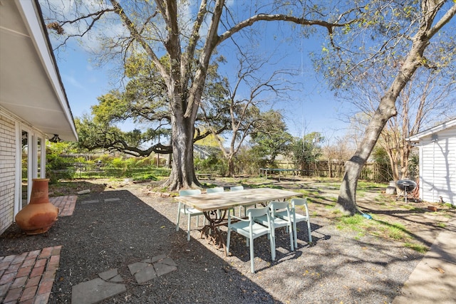 view of yard with a patio, outdoor dining area, and fence