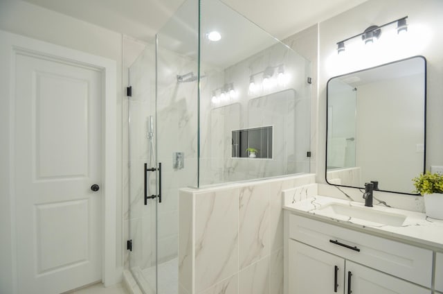 bathroom featuring vanity and a marble finish shower