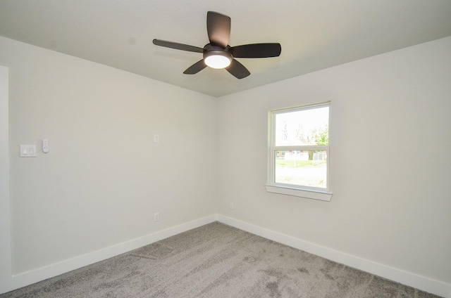 unfurnished room with baseboards, light colored carpet, and ceiling fan