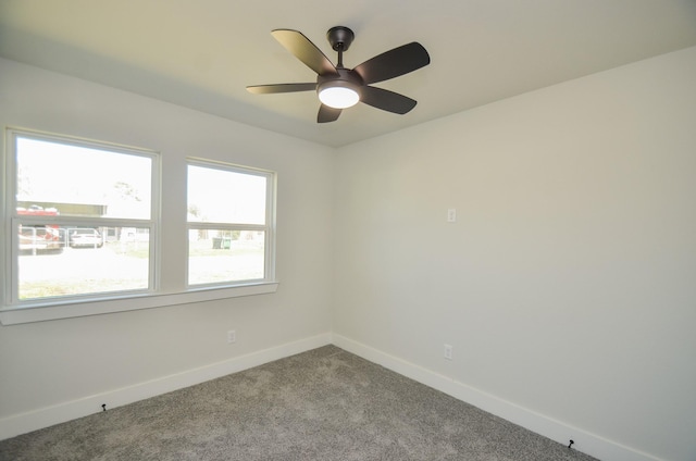 carpeted empty room with baseboards and ceiling fan