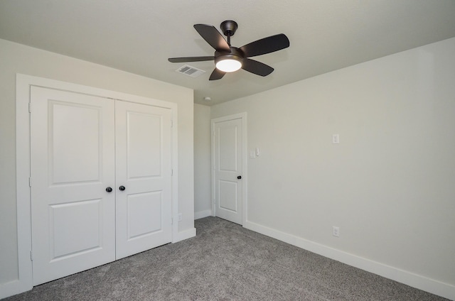 unfurnished bedroom with visible vents, ceiling fan, baseboards, carpet, and a closet