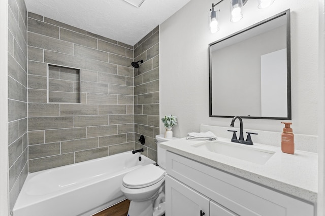 full bath featuring vanity, wood finished floors, shower / washtub combination, a textured ceiling, and toilet