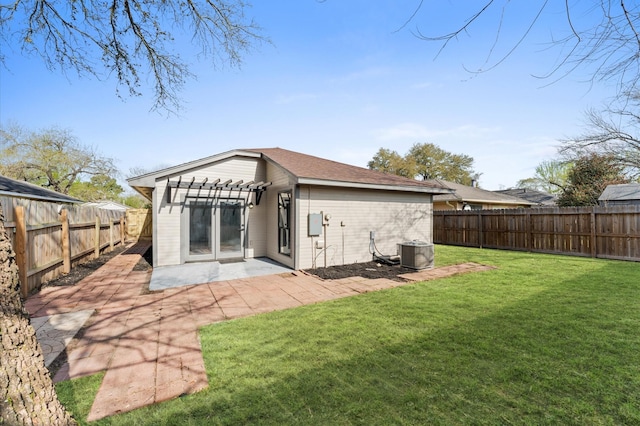 back of house with central AC, a lawn, a fenced backyard, a pergola, and a patio