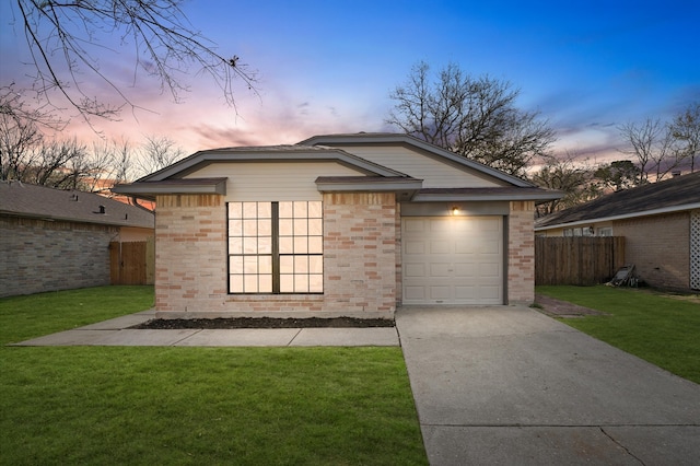 exterior space featuring fence, a lawn, and brick siding