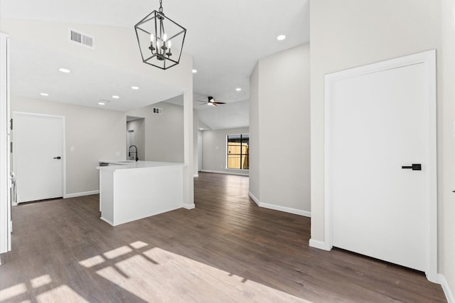 interior space with lofted ceiling, visible vents, dark wood-style flooring, and a sink