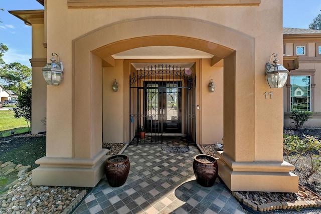 doorway to property with stucco siding and french doors