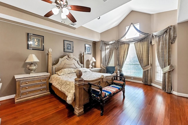 bedroom with visible vents, baseboards, vaulted ceiling, wood finished floors, and a ceiling fan