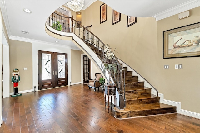 entryway featuring stairway, wood finished floors, arched walkways, and ornamental molding