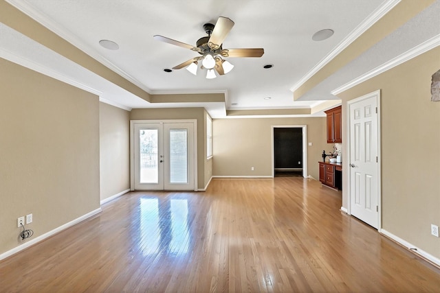 unfurnished living room with light wood-style flooring, ornamental molding, baseboards, and ceiling fan