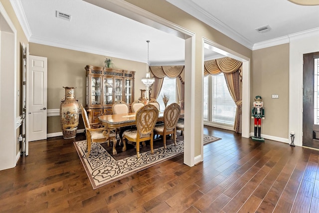 dining space with visible vents, dark wood-style flooring, and crown molding