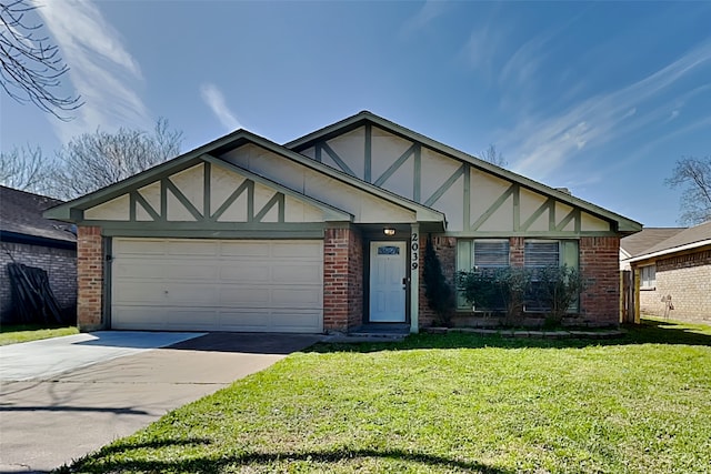 tudor home featuring brick siding, concrete driveway, a front yard, stucco siding, and an attached garage