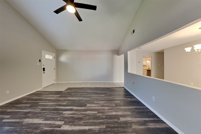 spare room featuring baseboards, high vaulted ceiling, wood finished floors, and ceiling fan with notable chandelier