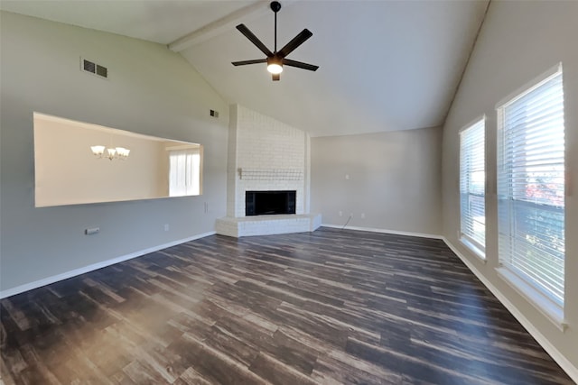 unfurnished living room featuring visible vents, plenty of natural light, dark wood-style floors, and ceiling fan with notable chandelier