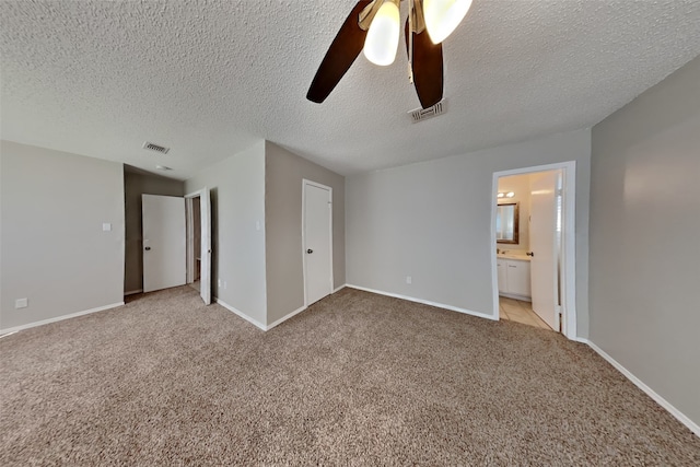 unfurnished bedroom featuring light carpet, visible vents, and baseboards