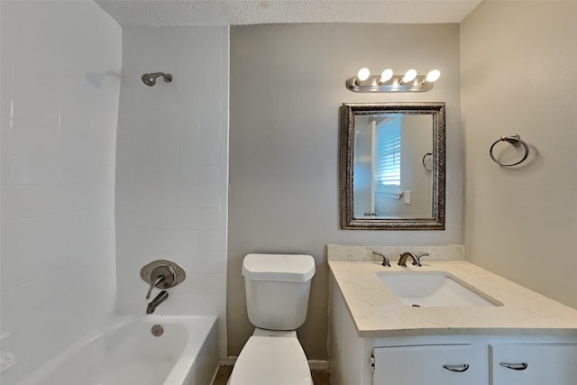 bathroom featuring toilet, vanity, and bathtub / shower combination