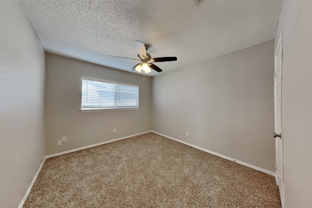 carpeted empty room featuring baseboards, a textured ceiling, and a ceiling fan