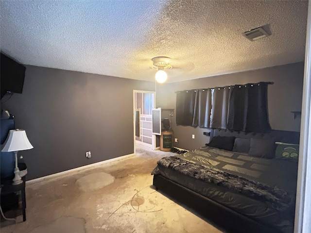 bedroom with baseboards, visible vents, a textured ceiling, and ceiling fan