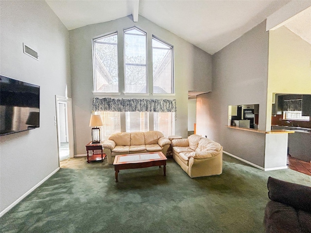 carpeted living area with visible vents, beamed ceiling, baseboards, and a healthy amount of sunlight