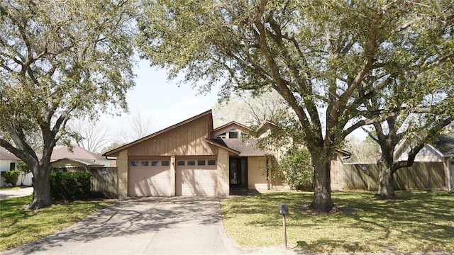 mid-century inspired home with a garage, concrete driveway, a front yard, and fence