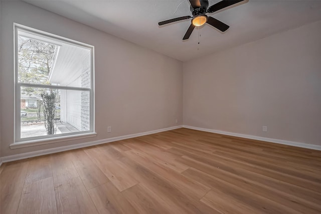 spare room featuring light wood finished floors and baseboards