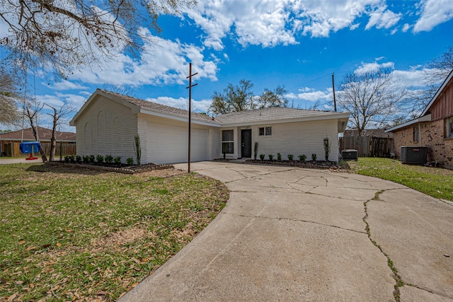 view of front facade featuring an attached garage, cooling unit, a front lawn, and driveway