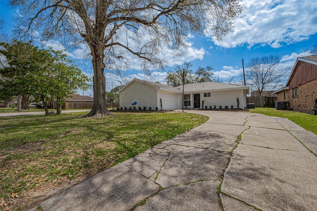 view of home's exterior with concrete driveway, fence, a lawn, and a garage