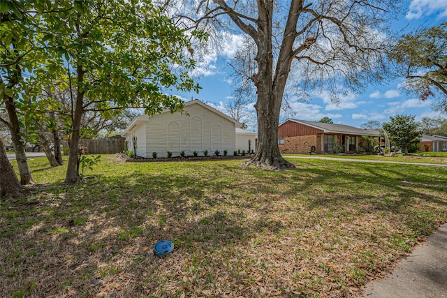 exterior space featuring a yard and fence