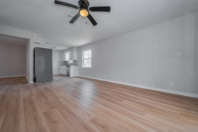 unfurnished living room featuring visible vents, baseboards, a ceiling fan, and light wood finished floors