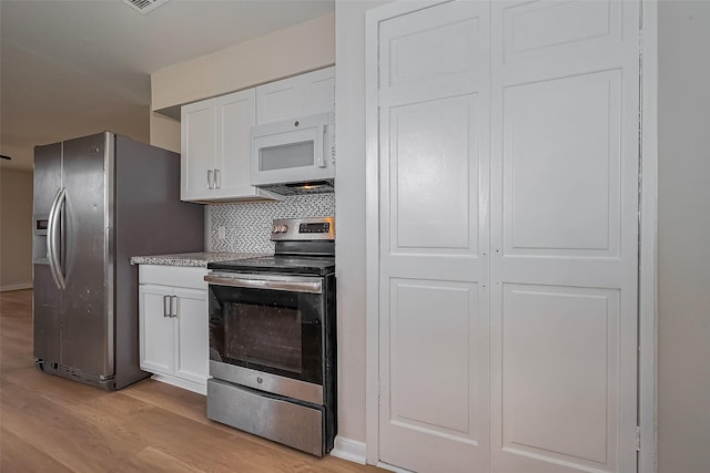 kitchen featuring backsplash, light wood-type flooring, light countertops, white cabinets, and stainless steel appliances