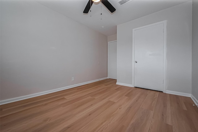 unfurnished bedroom featuring light wood finished floors, visible vents, ceiling fan, and baseboards