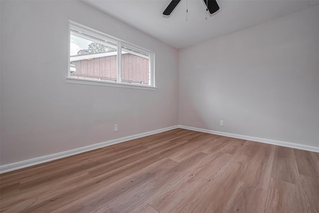 unfurnished room featuring baseboards, wood finished floors, and a ceiling fan