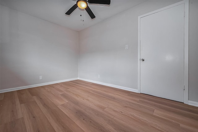 unfurnished room with light wood-style flooring, baseboards, and ceiling fan