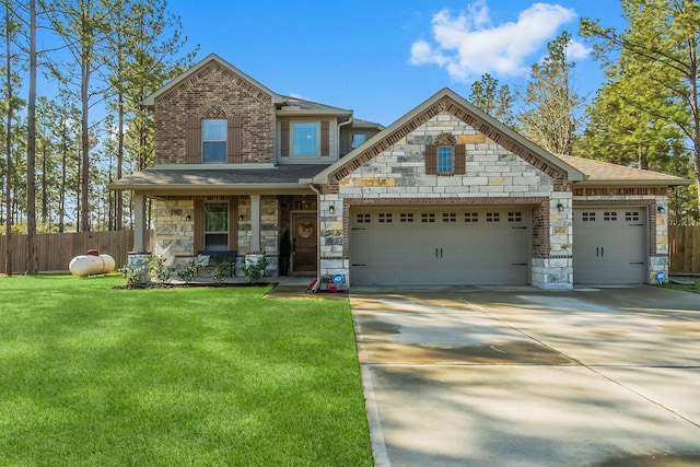 view of front facade featuring stone siding, a front lawn, an attached garage, and fence