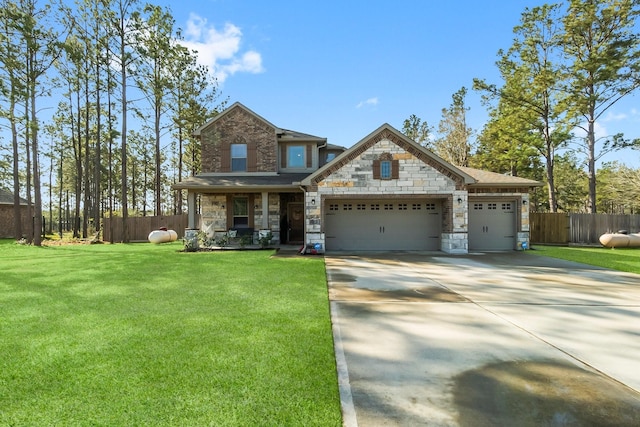 view of front facade with stone siding, fence, concrete driveway, a front yard, and a garage