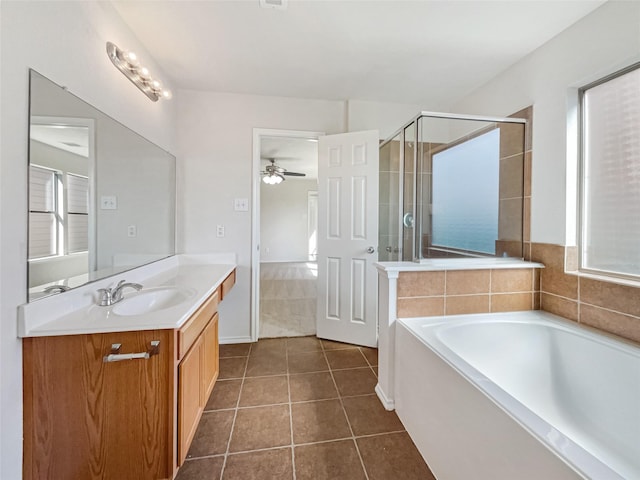 full bathroom featuring a ceiling fan, plenty of natural light, a shower stall, tile patterned flooring, and vanity