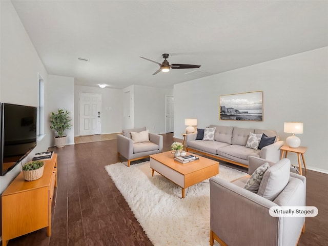 living area featuring dark wood-type flooring, a ceiling fan, and visible vents