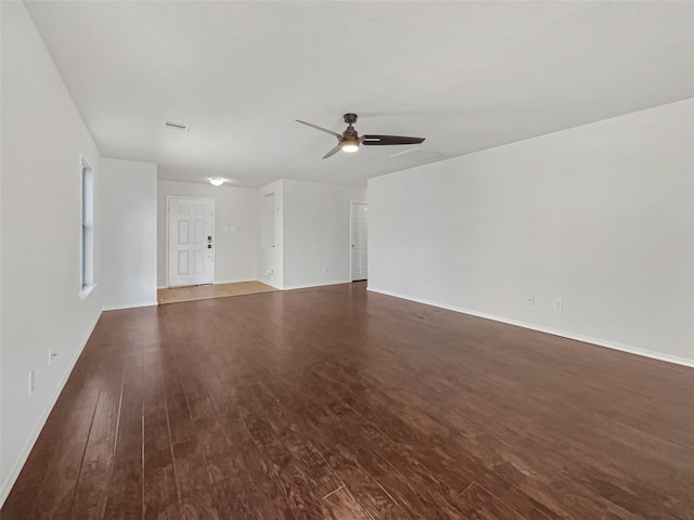 unfurnished room with visible vents, baseboards, wood finished floors, and a ceiling fan