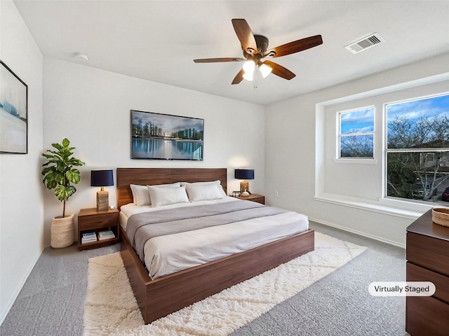 bedroom featuring visible vents, baseboards, ceiling fan, and carpet flooring