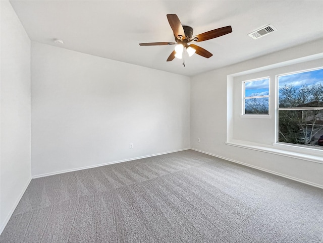 unfurnished room featuring visible vents, baseboards, carpet, and ceiling fan