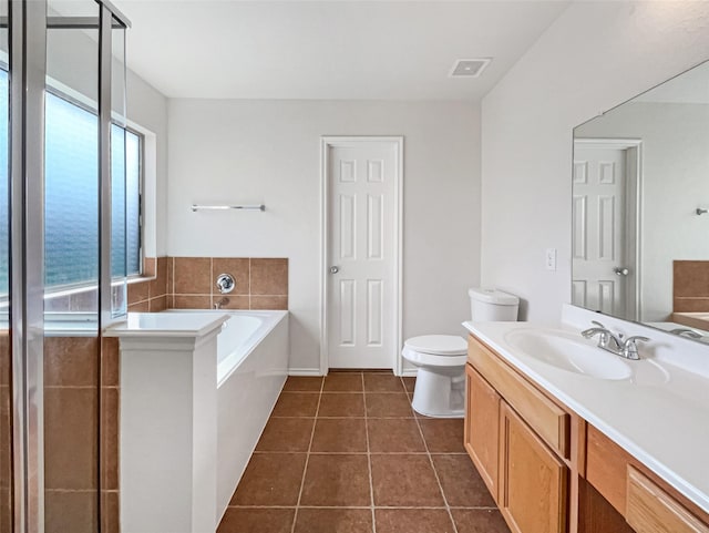 bathroom featuring visible vents, toilet, a bath, tile patterned floors, and vanity