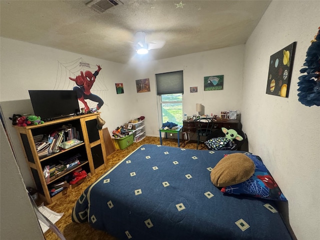 bedroom featuring visible vents, a textured ceiling, and a ceiling fan