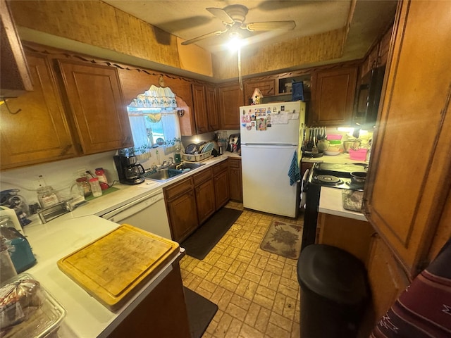 kitchen featuring white appliances, brown cabinetry, light countertops, and a sink