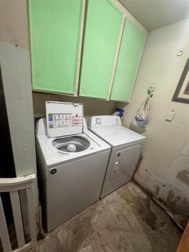 washroom with washer and clothes dryer and cabinet space