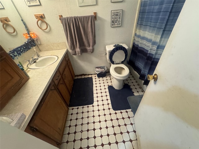 bathroom with vanity, tile patterned floors, toilet, and a shower with curtain