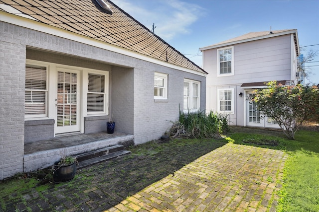 rear view of house with french doors and brick siding