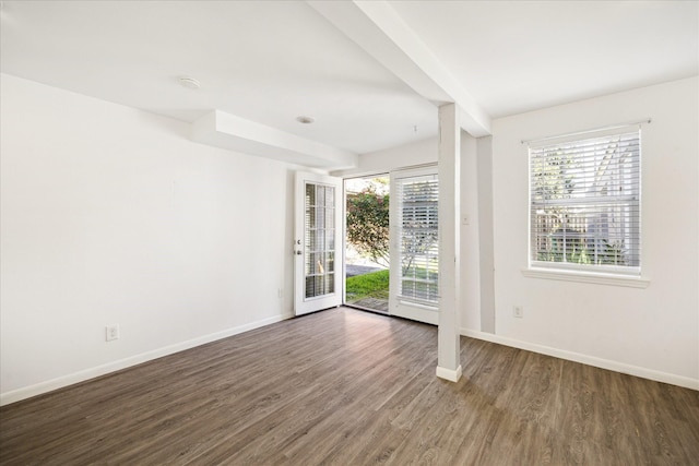 spare room with wood finished floors and baseboards