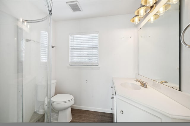 full bath featuring vanity, wood finished floors, a shower with shower door, visible vents, and toilet