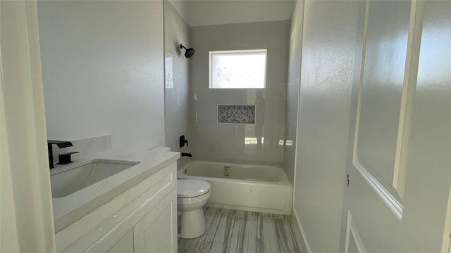 bathroom featuring vanity, toilet, and tub / shower combination