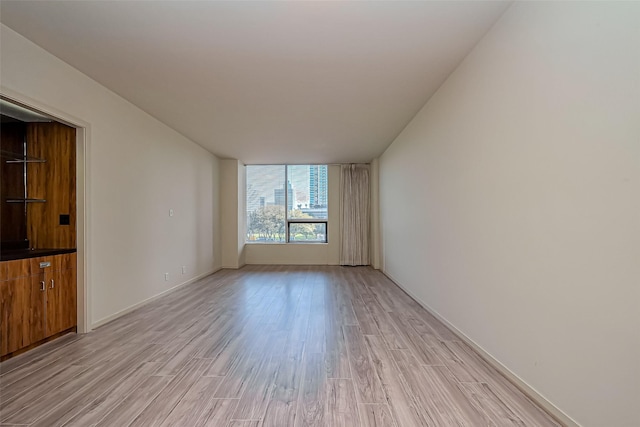 unfurnished room with light wood-style floors