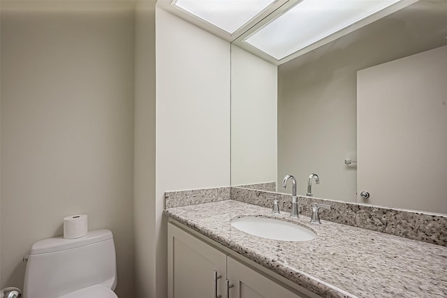 bathroom with toilet and vanity